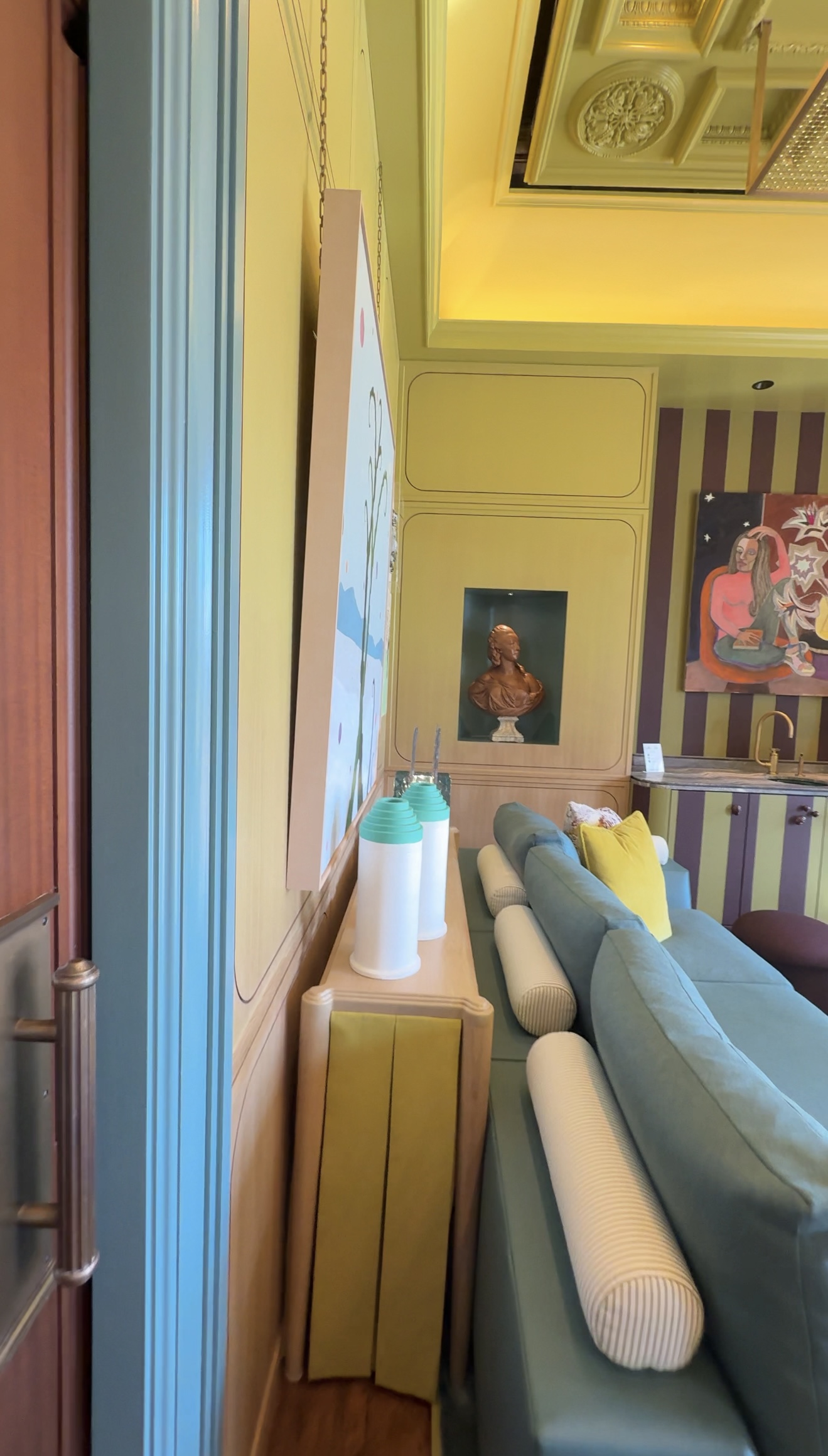 A lime green ombre room featuring bold artwork, bright accents, and soft pastel architectural details.