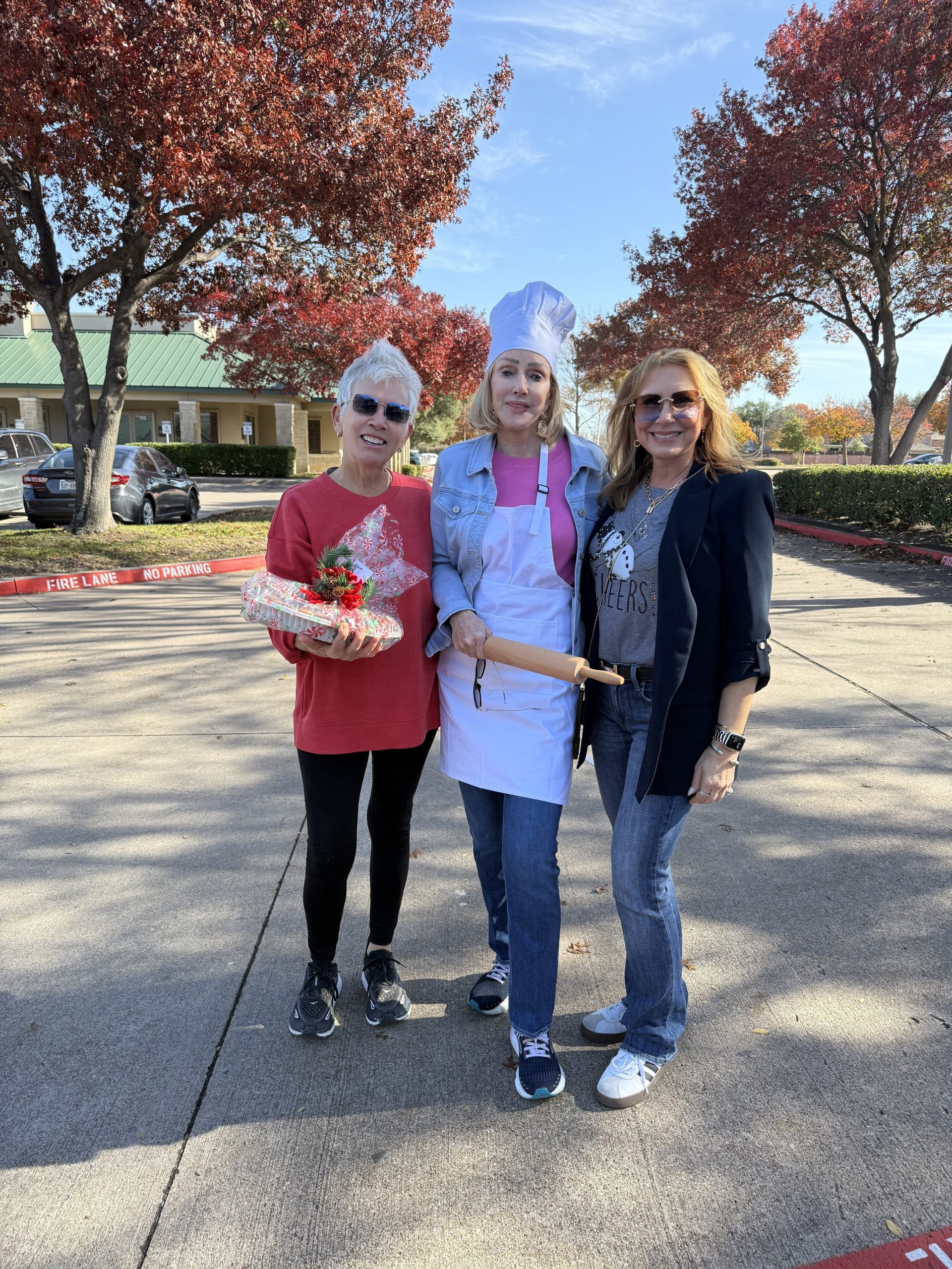 Smiling clients and families at Jan Richey Team holiday pie day luxury real estate event