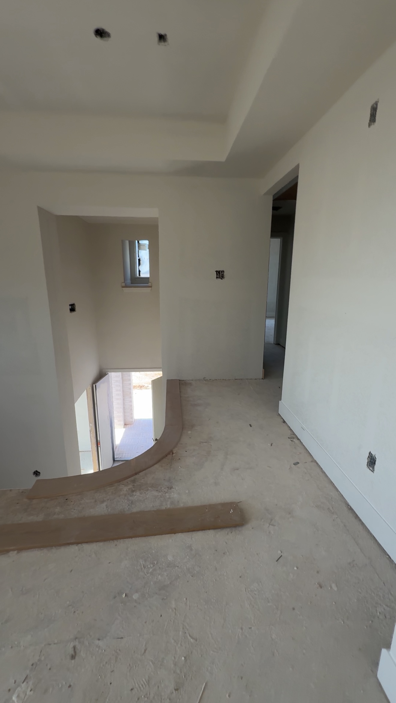 Luxury new construction upstairs during early build phase with unfinished entryway