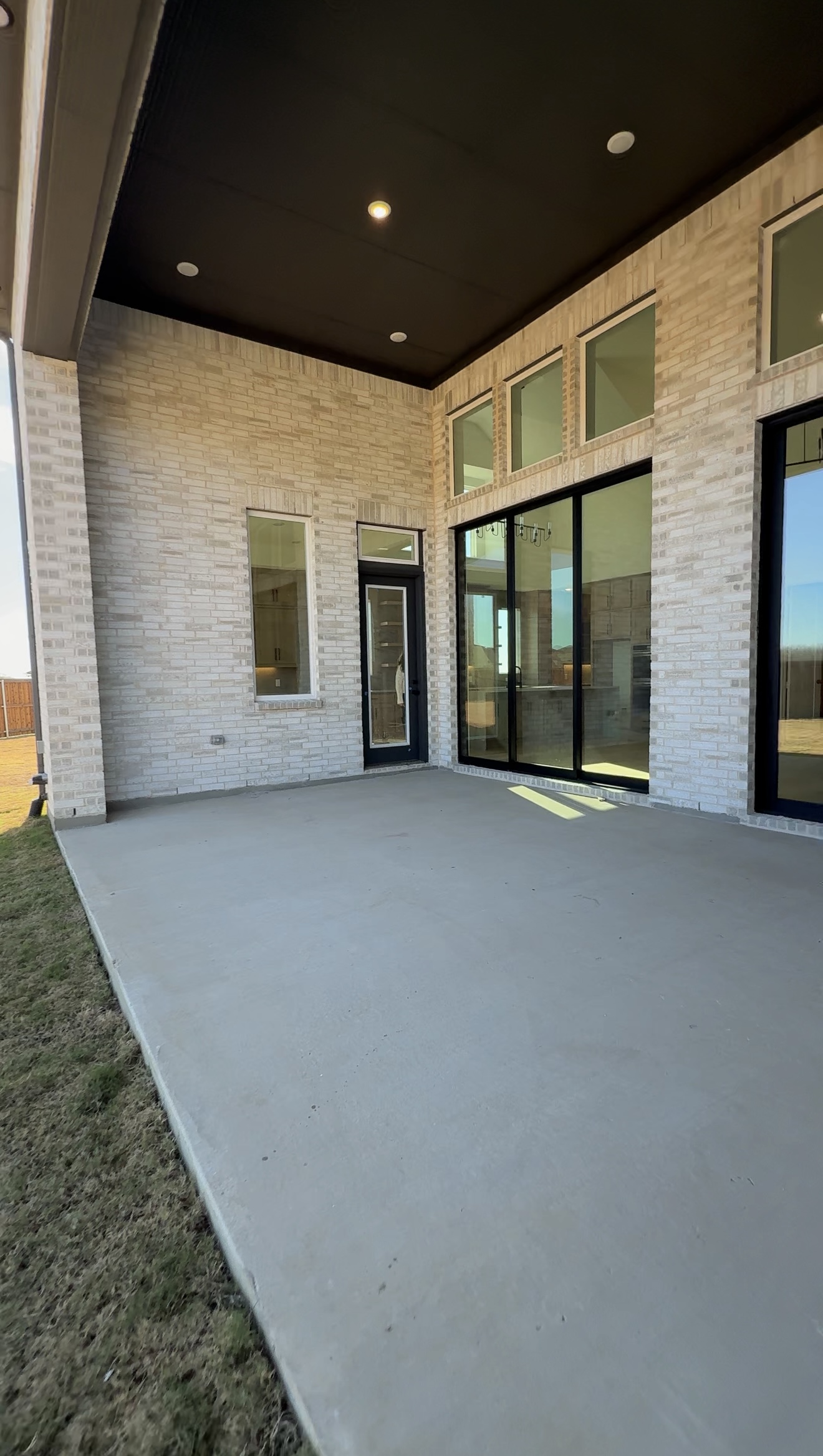 Luxury new construction covered patio with spacious outdoor living area in a Texas custom home