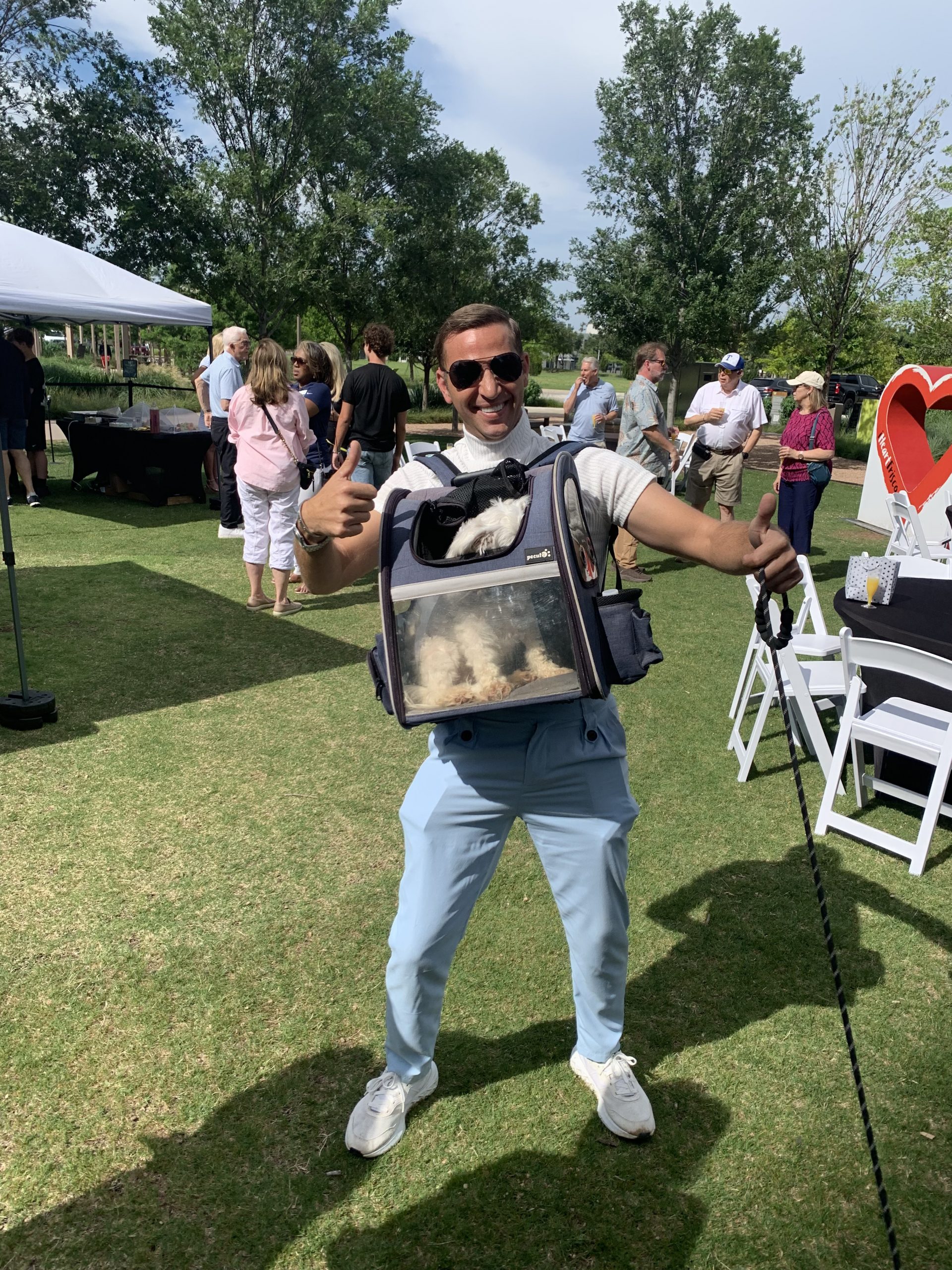Carl Hill holding a rescue dog at the Happy FurEver Dog Park ribbon cutting in Frisco, Texas
