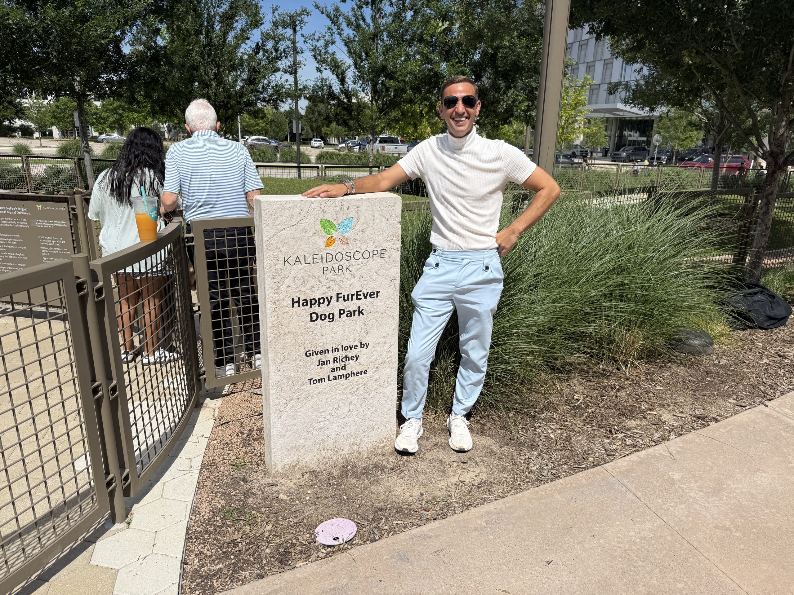 Carl Hill at the Happy FurEver Dog Park sign at Kaleidoscope Park in Frisco, Texas
