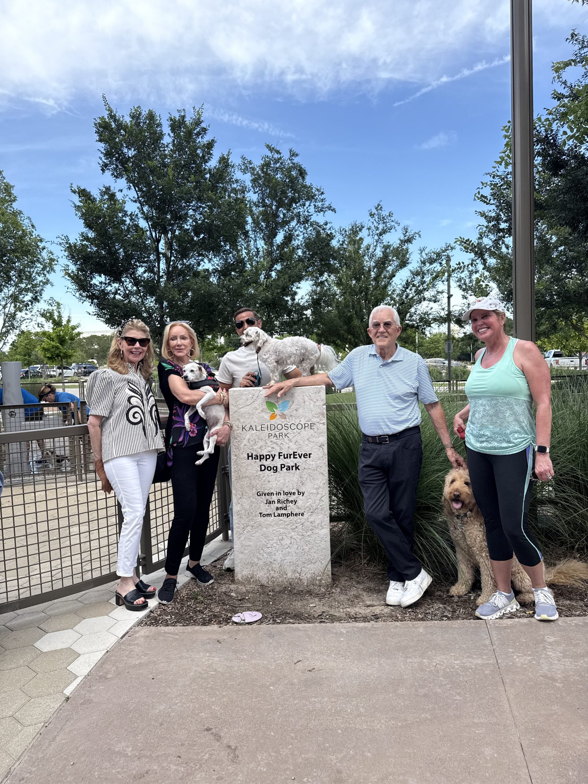 Donna Eagan, Jan Richey, Tom Lamphere, Carl Hill, and a guest at the Happy FurEver Dog Park sign in Frisco, Texas