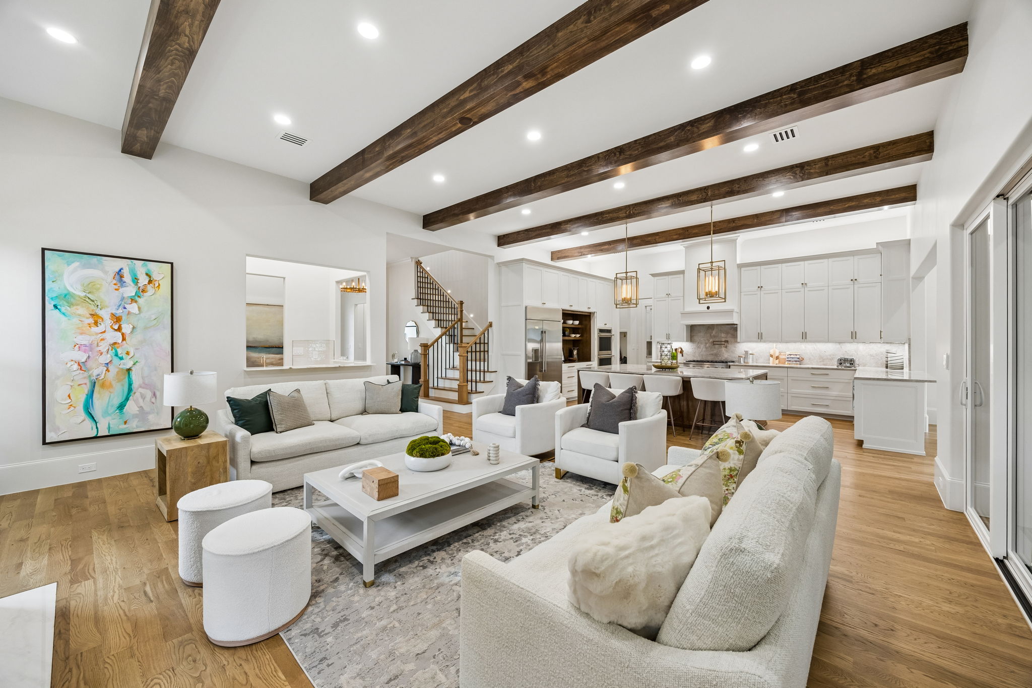Living room with staircase and kitchen at 9939 Ontario Lane Dallas
