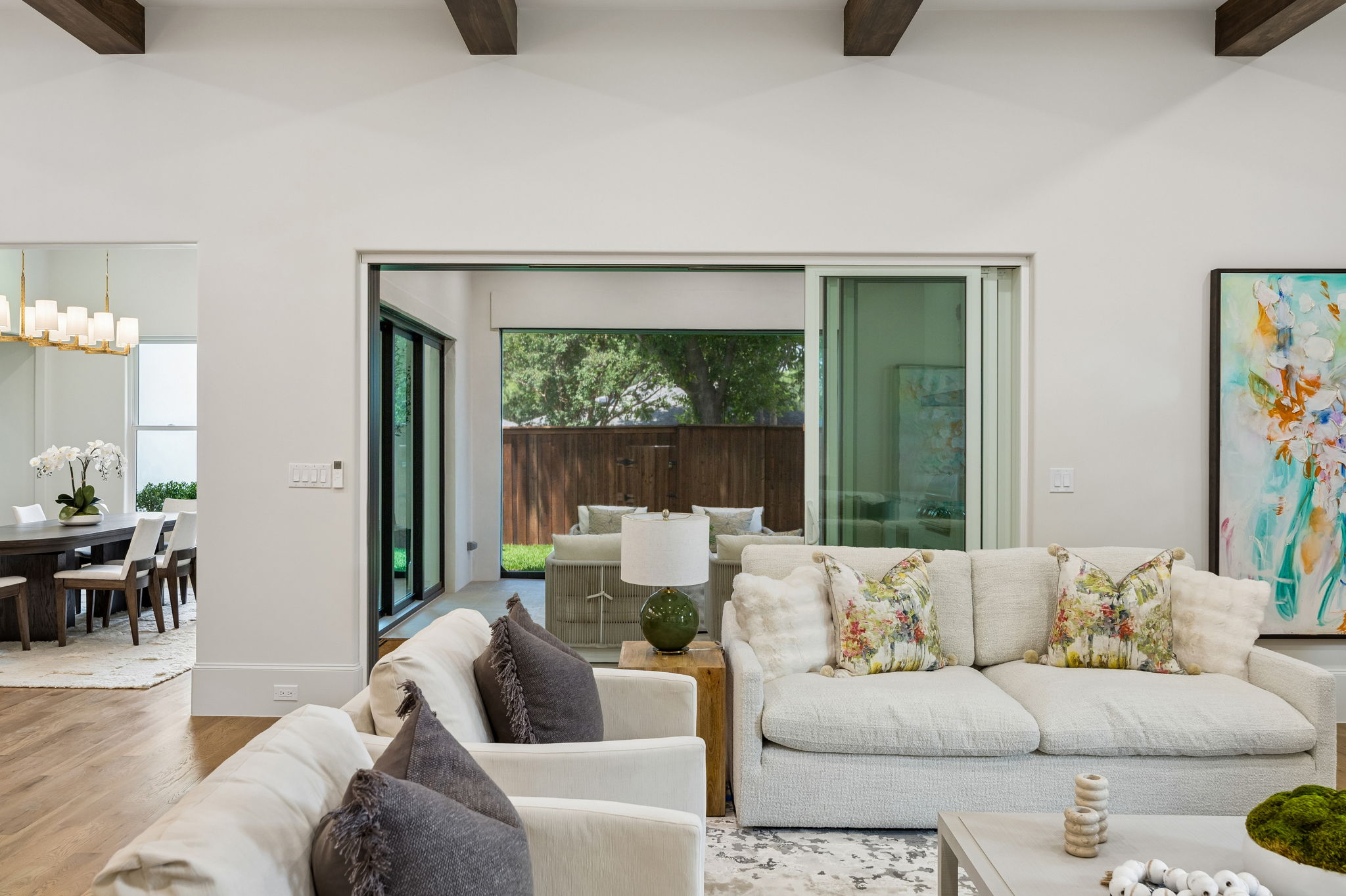 Living room with sliding glass doors open to covered patio at 9939 Ontario Lane